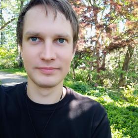 Headshot photo of Alex looking towards the camera